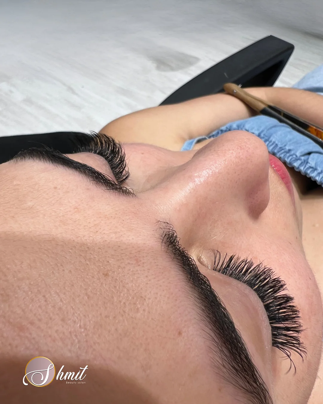 Especialista aplicando extensiones de pestañas pelo a pelo en Shmit Beauty Salon Madrid